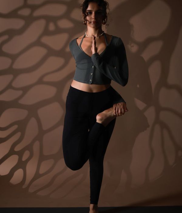 Woman in a calm yoga pose, embodying wellness and balance.